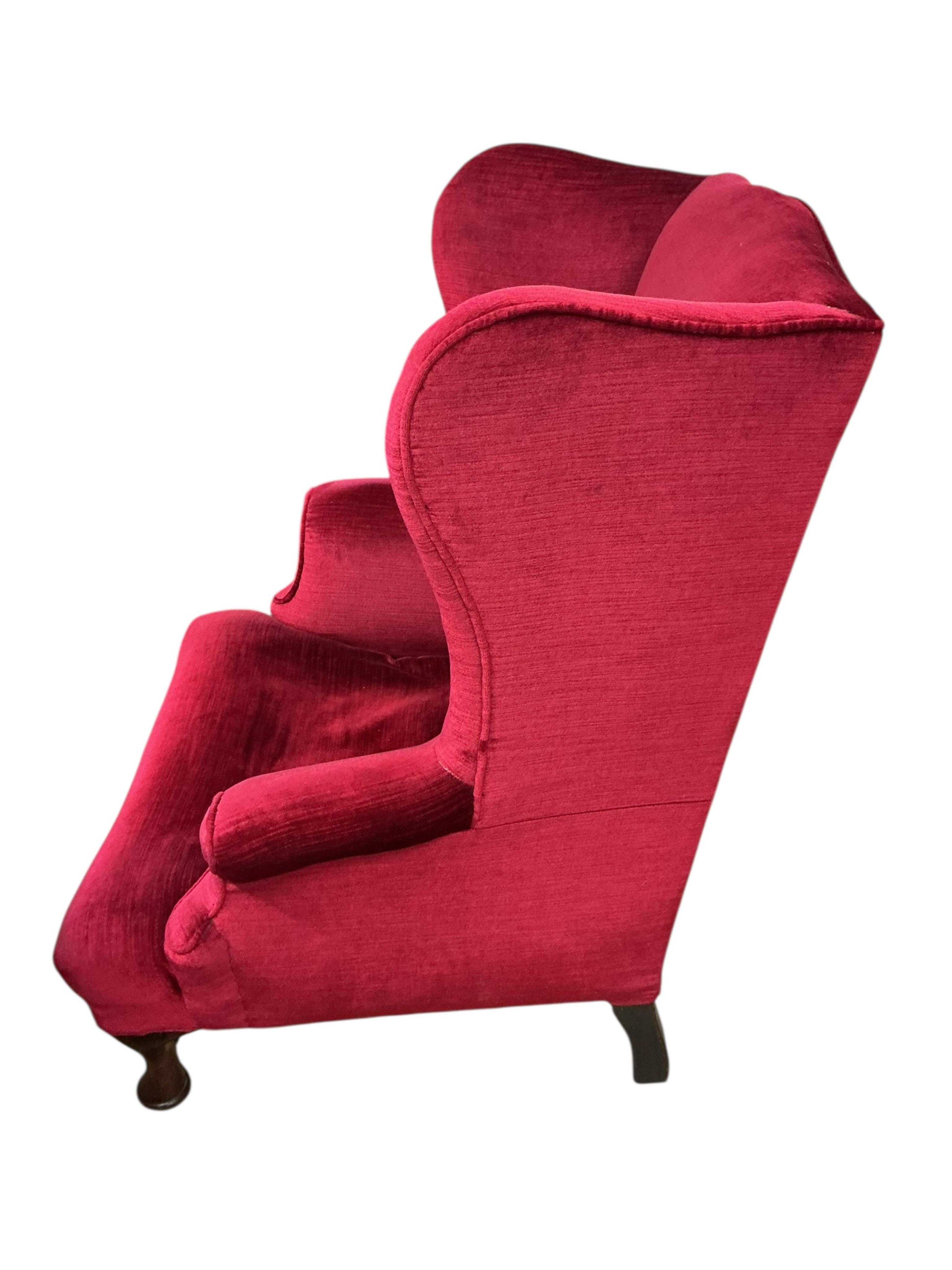 An early 20th century Queen Anne style upholstered wing armchair, width 83cm, depth 86cm, height 90cm